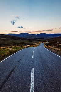 photo of empty road between green grass thumbnail