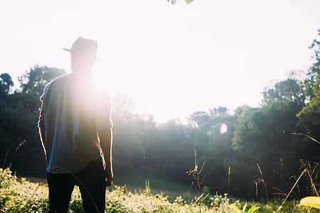 man standing on grass field thumbnail