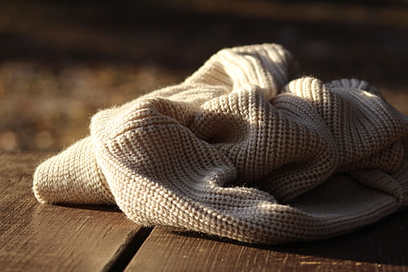 closeup photo of white crochet cloth on brown wood thumbnail