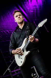 Man in Black Dress Shirt Playing Guitar thumbnail
