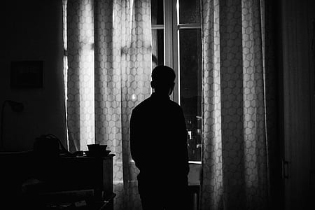 silhouette of man looking at window thumbnail