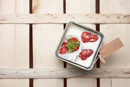 square strawberry on milk container on top of beige surface thumbnail