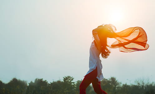 silhouette photo of standing woman facing windward thumbnail