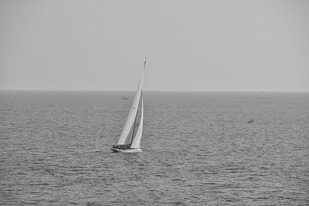 Grayscale Photography of Boat on Calm Body of Water thumbnail