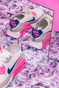 pair of white-and-pink Nike AirMax shoes mirror reflection thumbnail
