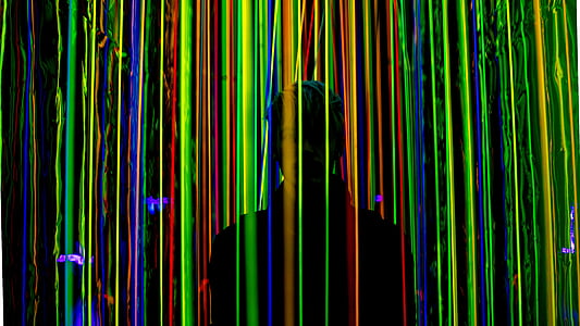 man in middle of colored strings thumbnail