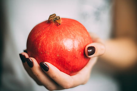Red Pomegranate at Woman's Hand thumbnail