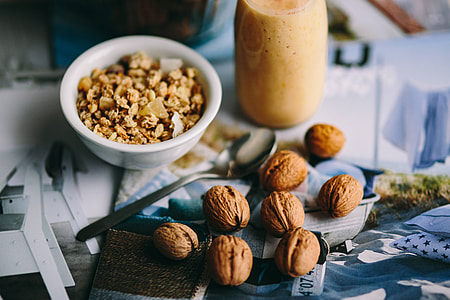 Jar full of walnuts with a fresh healthy shake and musli in a bowl thumbnail