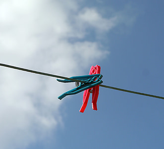 two blue and red clothespin on black cable thumbnail