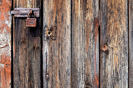 brown and grey wooden door with stained padlock thumbnail