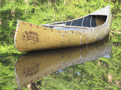photo of brown canoe on body of water thumbnail