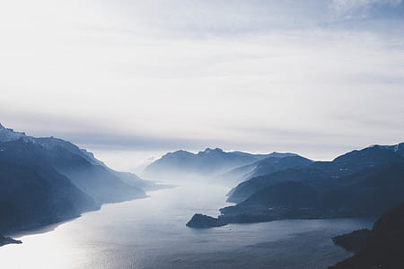 aerial view photography of body of water between mountain thumbnail
