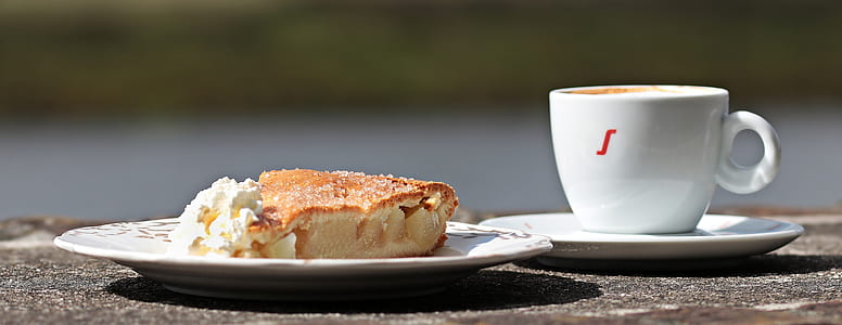 white ceramic tea cup near baked bread on plate thumbnail
