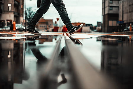low-angle of person walking on wet road thumbnail