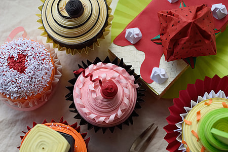 three cupcakes near red and white box thumbnail
