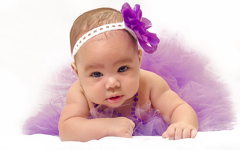 baby wearing purple headband and mesh dress thumbnail