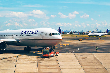 white and gray airliner on hangar thumbnail