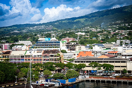 houses near body of water and mountain range during daytime thumbnail