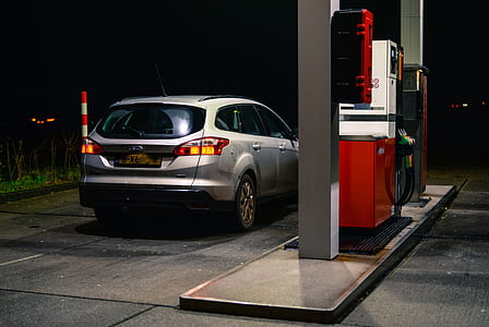 silver SUV parked beside gas station thumbnail