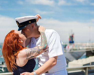 Navy Veteran Couple Kissing coming home from deployment thumbnail