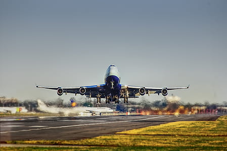 airplane about to land under white and gray sky thumbnail