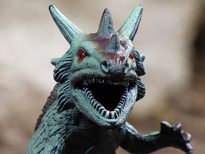 green dinosaur with three horns toy thumbnail