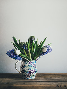 purple and white petaled flower in the vase on the top of the table thumbnail
