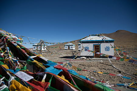 white concrete sheds near brown mountain thumbnail
