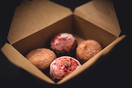 four pastries inside brown box thumbnail