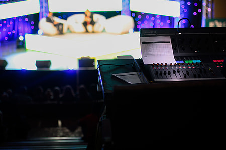 selective photography of audio mixer with background of two person in sofa thumbnail