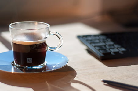 clear glass cup filled with coffee thumbnail