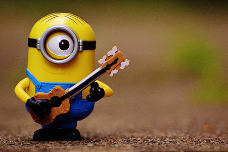 shallow focus photography of Stuart The Minion playing guitar display figure thumbnail