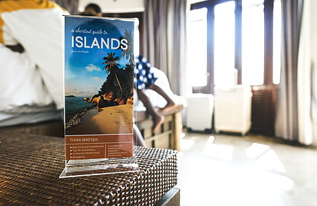 Selective Focus Photography Islands Card on Brown Wicker Table thumbnail