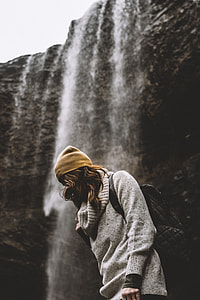 woman standing near waterfalls thumbnail