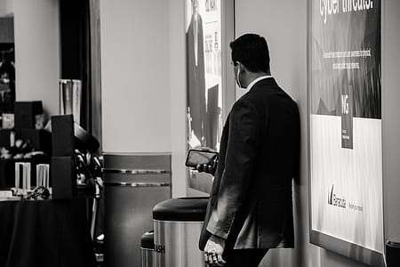 Man in Suit Jacket Near Poster thumbnail