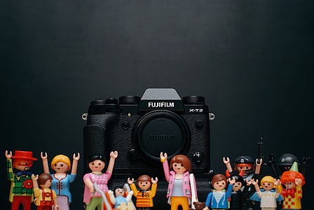 black Fujifilm camera and assorted toys thumbnail