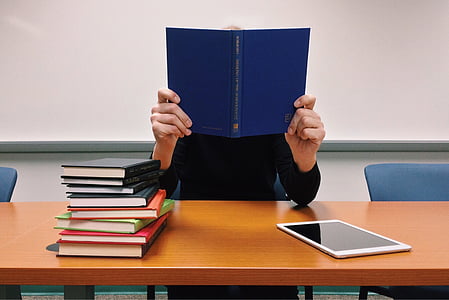 person with books on table thumbnail