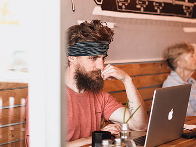man using silver MacBook by the table thumbnail