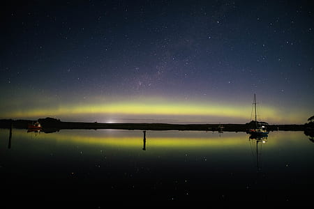 boat and house on body of water during nighttime thumbnail