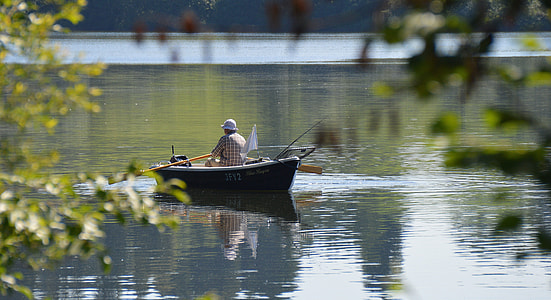 man rowing a boat on river thumbnail
