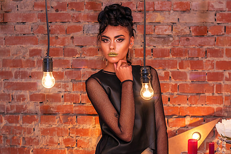 woman wearing black mesh long-sleeve top isolated with red brick background thumbnail