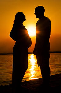 silhouette of couple at sea shore thumbnail