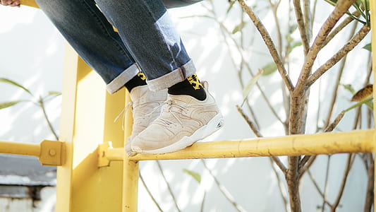 person on yellow steel railings thumbnail
