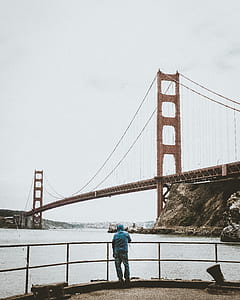 man standing near Golden Gate Bridge during daytime thumbnail