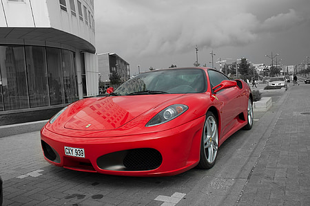 selective color photography of red Ferrari sports coupe thumbnail