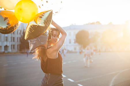 woman in brown top holding balloon thumbnail