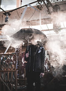 man holding umbrella during daytime thumbnail