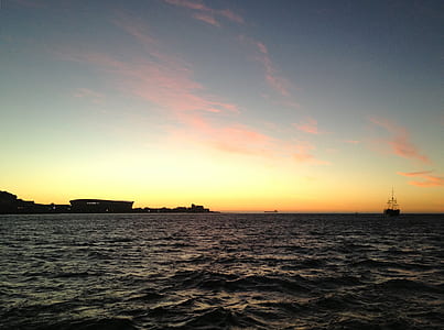 photo of beach under blue and yellow sky thumbnail