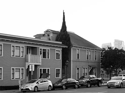 assorted vehicles parked near wooden houses thumbnail