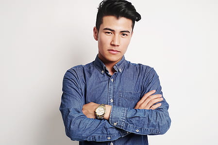 man in blue chambray long-sleeve shirt with gold-colored round watch thumbnail